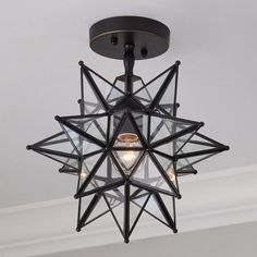 a star shaped light fixture hanging from the ceiling