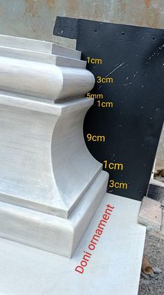 a close up of a white pillar with measurements