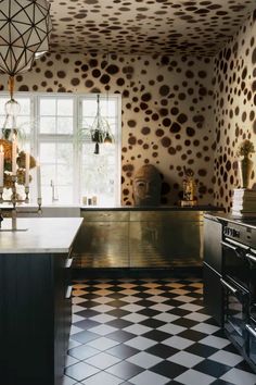 a kitchen with black and white checkered flooring, an oven and stove top