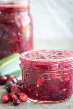 cranberry sauce with cucumbers and celery next to it on a table