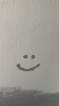 a smiley face drawn on the wall