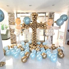 a room filled with balloons and decorations in gold, blue and white colors on the floor