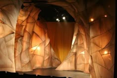 the stage is set up for a show with rock formations on it and lights in the background