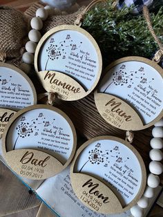 four personalized wooden ornaments with names and date