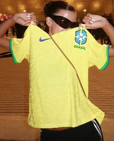 a woman in a yellow shirt and sunglasses