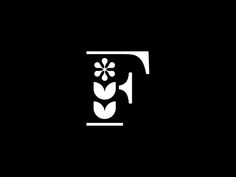 the letter t is made up of flowers and leaves in white on a black background