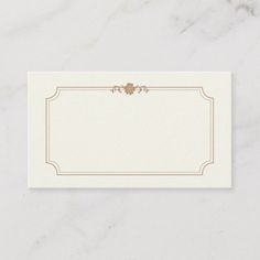 a white business card with a gold border