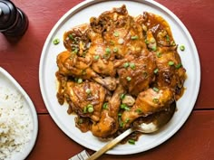 a plate of chicken and rice on a table