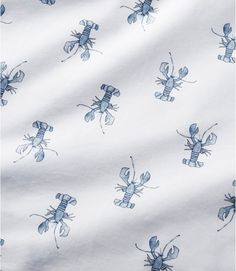 a blue and white fabric with bugs on it