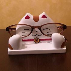 a ceramic cat with glasses on it's head