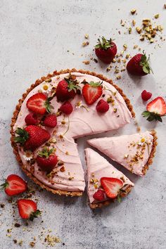 there is a pie with strawberries on the top and one slice missing from it