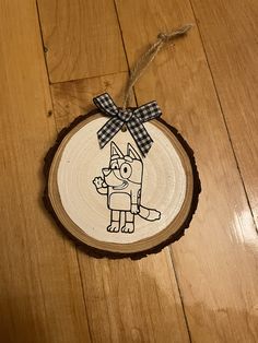 a wooden ornament with an image of a dog on it