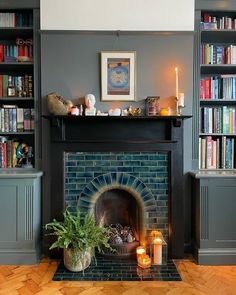 a living room with a fire place and bookshelves