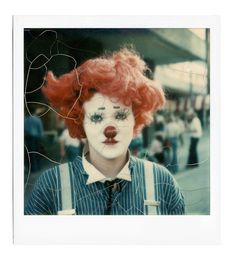 a woman with red hair and clown makeup