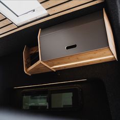 the interior of a vehicle with wood and metal accents on the wall, along with an overhead window