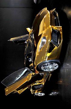 a shiny gold motorcycle is parked in the dark