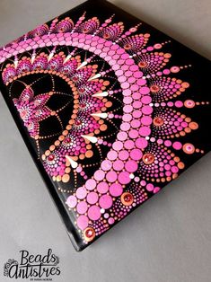 a black and pink box with designs on it