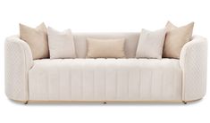 a white couch with several pillows on it