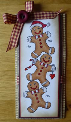 a card with three gingerbreads on it and a ribbon around the edge that says ho ho ho