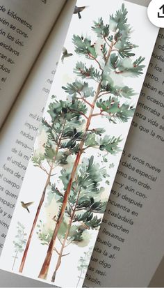 an open bookmark with watercolor trees and birds on it