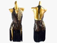 two mannequins dressed in black and gold with chains hanging from the back