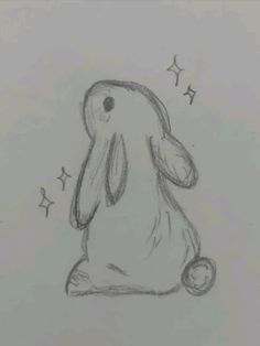 a drawing of a bunny sitting on the ground with stars around it's head