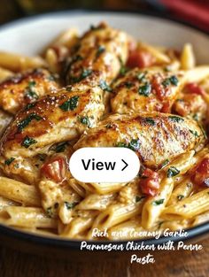 a white plate topped with pasta and chicken