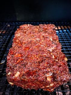 a large piece of meat cooking on top of a grill