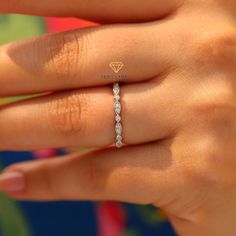 a woman's hand with a diamond ring on her left hand and the word fearless written in gold