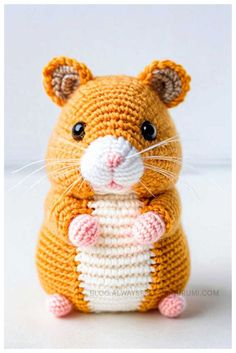 a crocheted hamster sitting on its hind legs