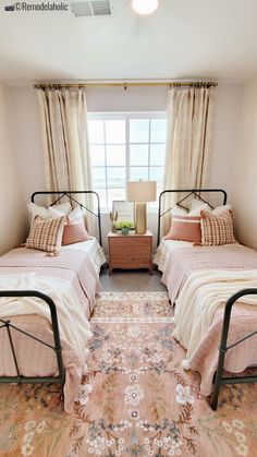 two twin beds in a small room with beige walls and carpeted flooring on the side