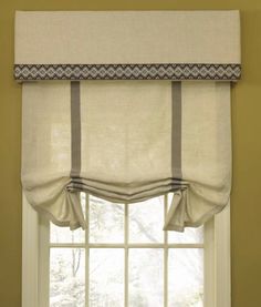 a window with a white curtain and some windowsills