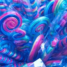 there are many colorful lollipops wrapped in plastic