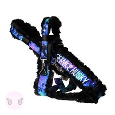 a blue and black dog harness with furry fur on it's back, featuring the name