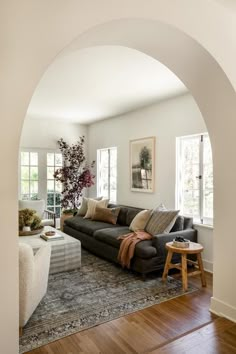 a living room filled with furniture and lots of windows