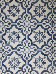 a blue and white wallpaper with an intricate design on it's surface,