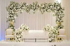 an image of a wedding setup with flowers and greenery on the stage set up