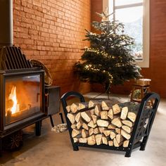 a pile of logs sitting in front of a fire place next to a christmas tree