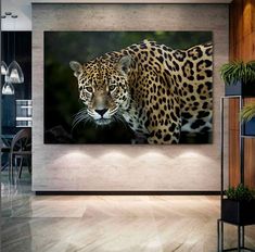 a leopard is walking through the room with its head turned to look like it's looking