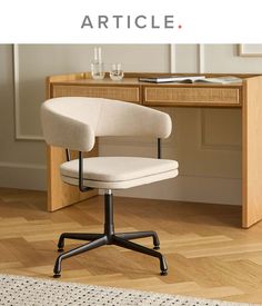 an office chair sitting on top of a hard wood floor next to a wooden desk