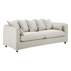 a white couch with four pillows on it