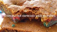 brown butter espresso m & m blondies are cut in half and stacked on top of each other