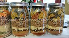 four mason jars filled with different types of food