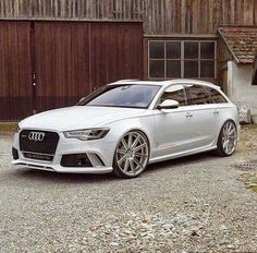 a white car parked in front of a building