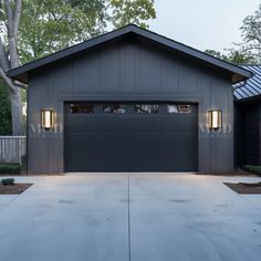 a garage with two lights on the side of it