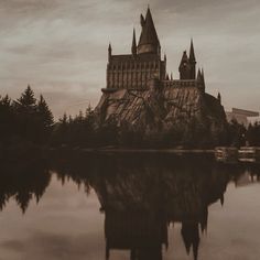 a castle with towers is reflected in the water