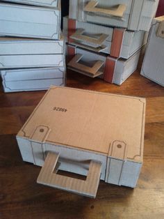 several cardboard boxes stacked on top of each other with one open box in the middle