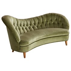 a green couch sitting on top of a wooden frame