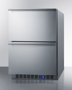 a stainless steel refrigerator sitting on top of a white counter next to a freezer