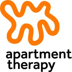 the apartment therapy logo with an orange and black swirl in the center, on a white background